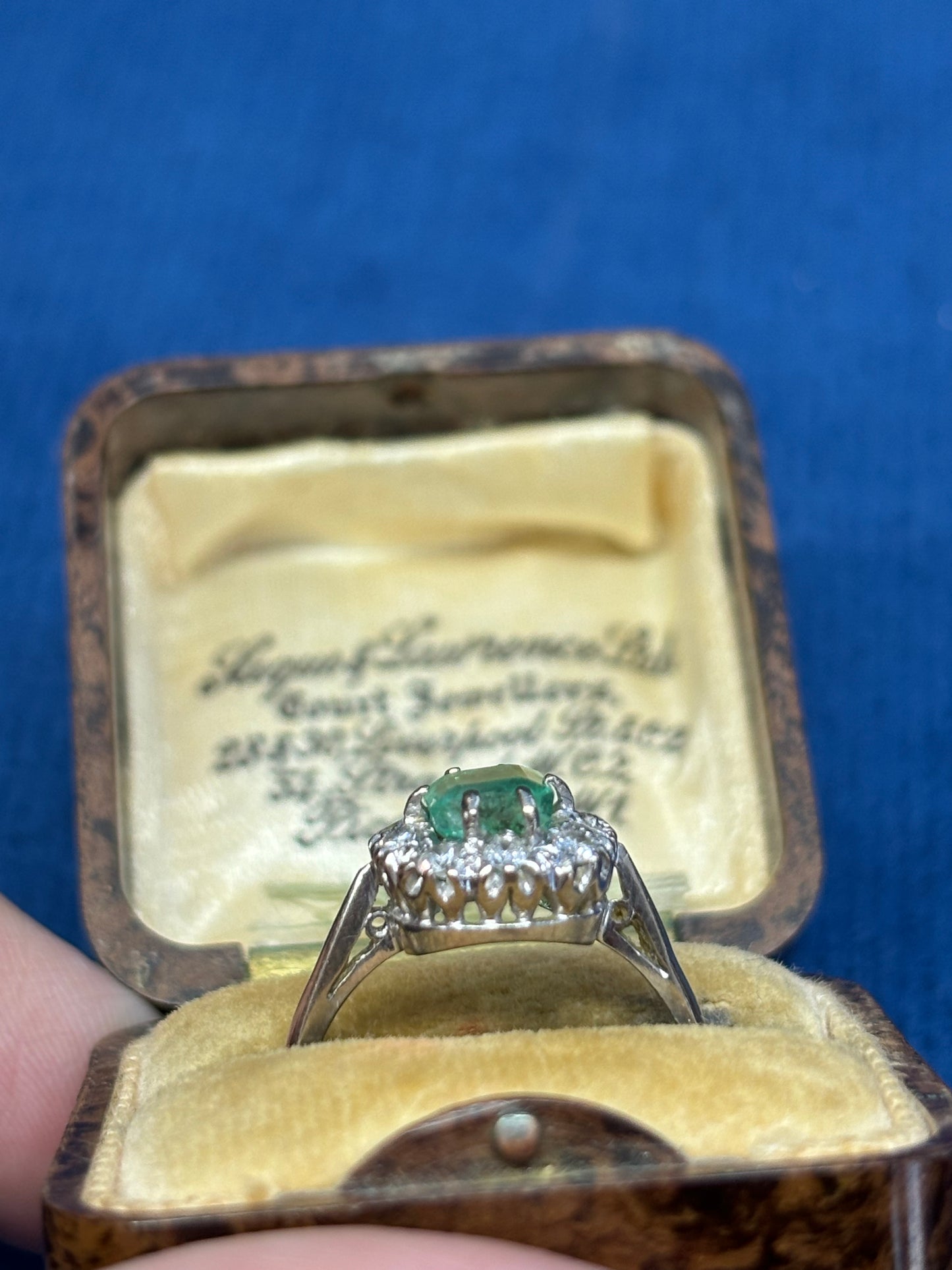 Cushion cut emerald and diamond ring