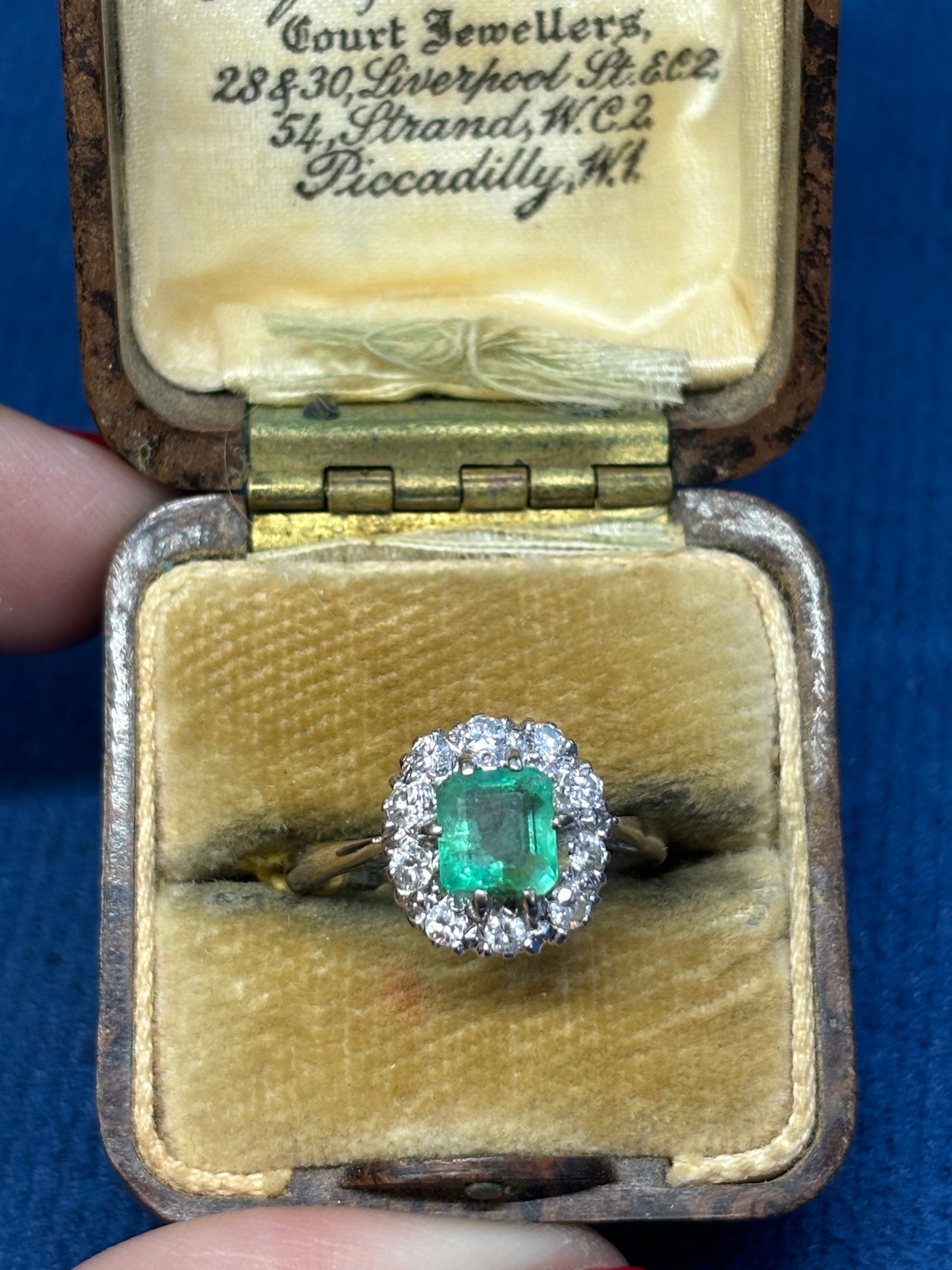 Cushion cut emerald and diamond ring