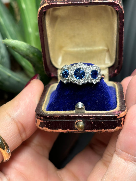 Sapphire and diamond daisy ring set in 18ct gold