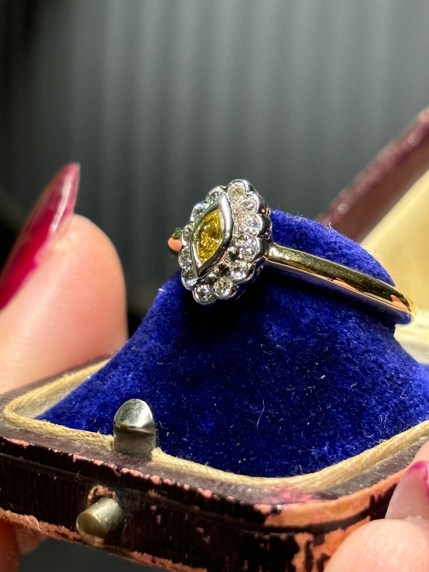 Marquise cut yellow diamond with diamond halo set in 18ct gold