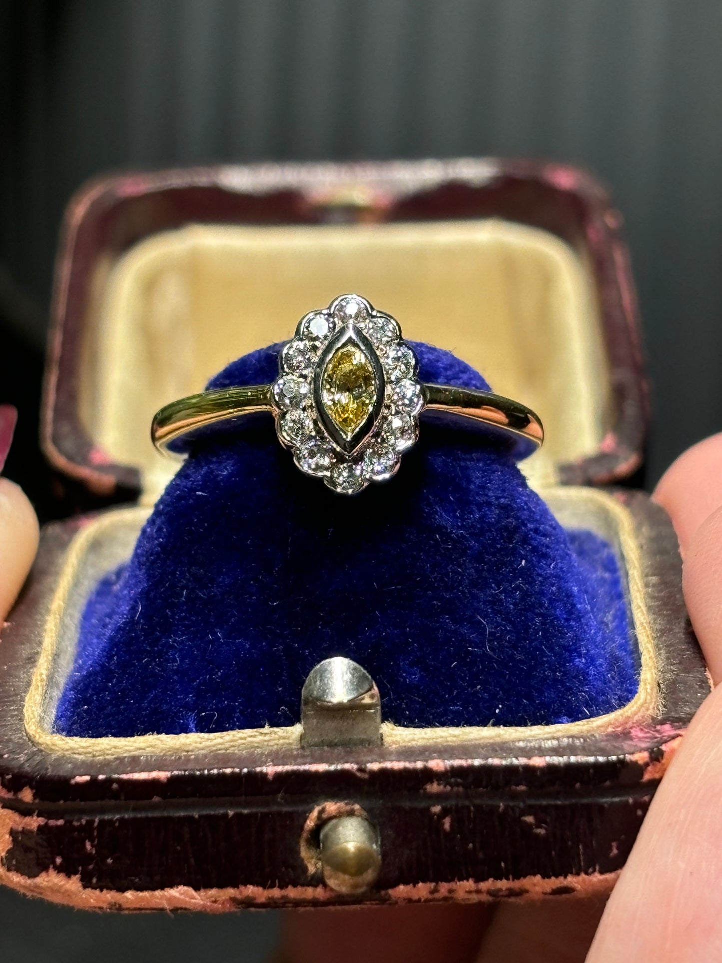 Marquise cut yellow diamond with diamond halo set in 18ct gold